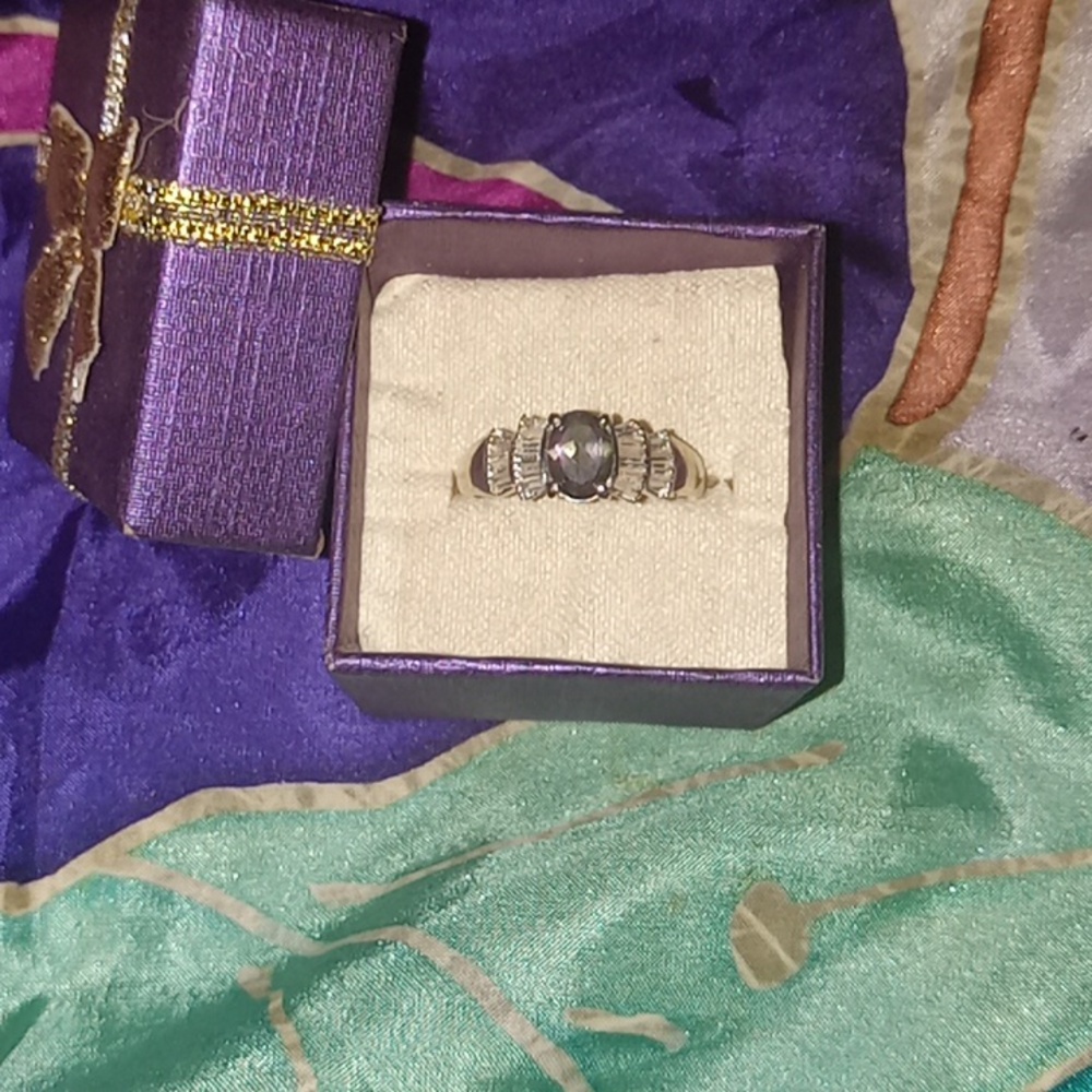 10kt gold mystic topaz ring with2 rows of bezel cut diamondson bothsides, size 7